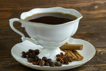 cup of coffee and anise on a wooden background