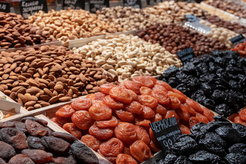 Market counter with various assorted dried fruits and nuts. Healthy food. Local market place.