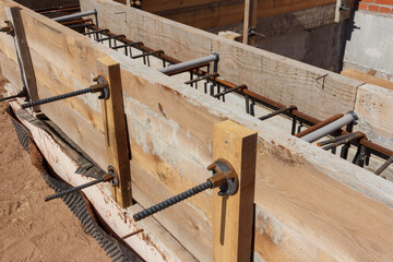 Panel formwork for the construction from wooden boards. Concrete works. Installation of a new foundation. Construction