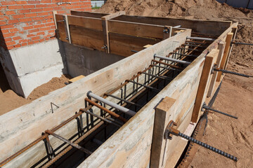 Panel formwork for the construction from wooden boards. Concrete works. Installation of a new foundation. Construction