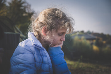 thinking girl sitting alone in sunny day