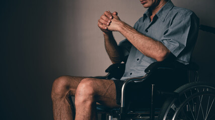 Obraz premium Lonely disabled man on wheelchair in the house, Depression occurs in people with disabilities who are alone at home.