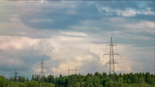 time-lapse. high-voltage power lines located along the forest.