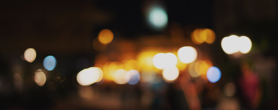 Blurred image. Defocused night city lights, banner format