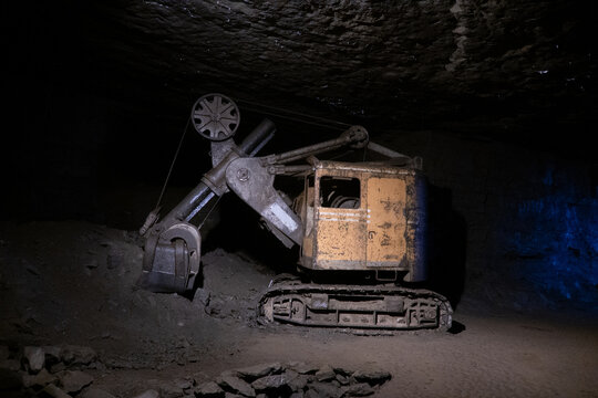 old excavator stands in an old coal mine
