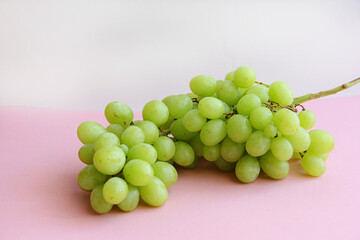 a bunch of green grapes on a light background