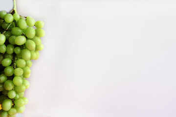 a bunch of green grapes on a white background