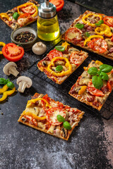 Homemade baking Detroit-Style pizza. Large rectangular Pepperoni pizza with mushrooms, salami and cheese on a stone tabletop. Copy space.