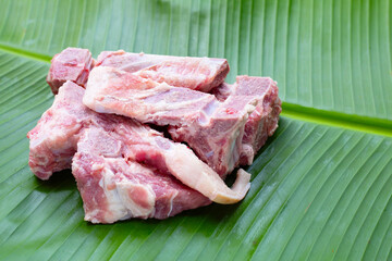 Raw pork bone on banana leaf