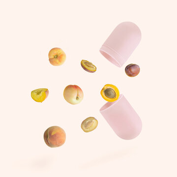 Minimal, aesthetic, arrangement made of pink pill and colorful summer fruits isolated on pastel beige background. Raw, healthy food and healthy life style idea. Food and remedies from nature concept.