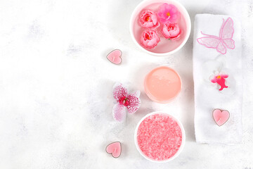 Spa and wellness composition with aromatic rose water, salt, roses, archidea flowers and sakura, towels, aromatherapy and skincare, lifestyle concept, invitation and advertising,
