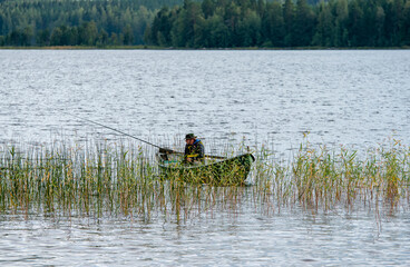 Fisherman on boat at lake