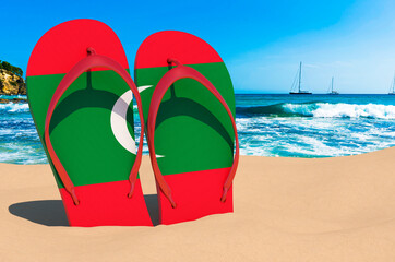 Flip flops with Maldivian flag on the beach. Maldives resorts, vacation, tours, travel packages concept. 3D rendering
