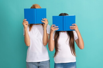 mother and daughter hiding behind books ready to study, literature