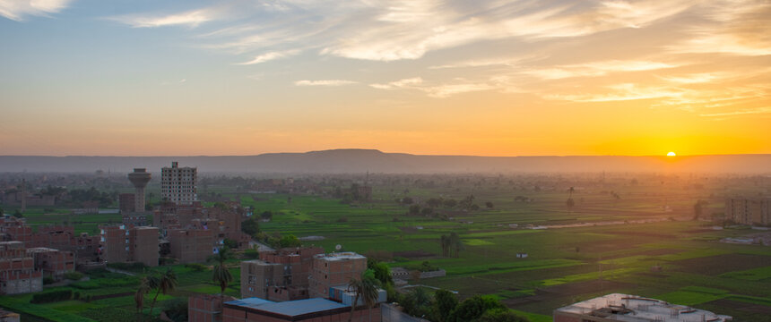 Sunrise scene of Naidah village with mountains in the background bordering the Nile valley