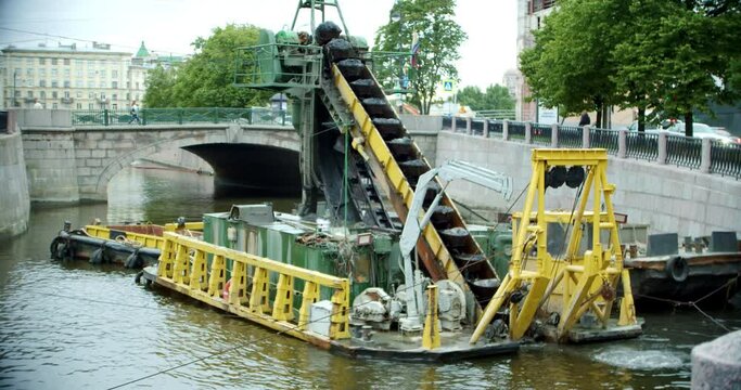dredging equipment in operation. working process on deepening the bottom of the river in the historical center of the city
