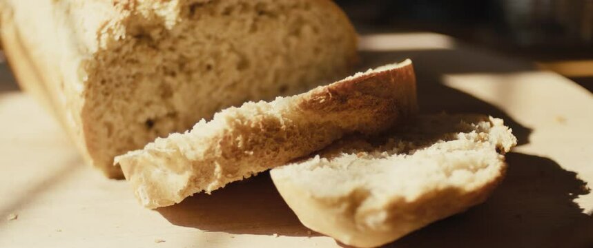 Slices of fresh hot bread baked at home kitchen healthy food close up