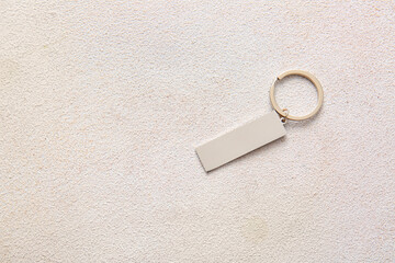 Stylish keychain on light background