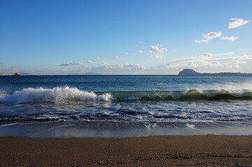 Wave breaking on beach in Napoli Italy