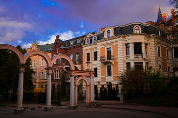 Lviv Ukraine old downtown living district with beautiful buildings architecture exterior facade in dusk lighting of sunset evening time in fall season of September