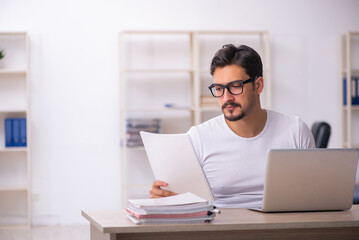 Young male student employee at workplace