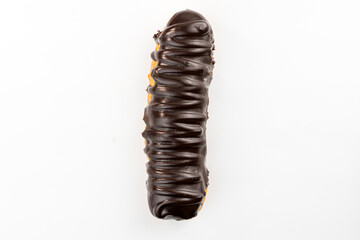 Dessert Bomba de Chocolate. Brazilian traditional éclair on a white background. Close-up macro. Selective focus.