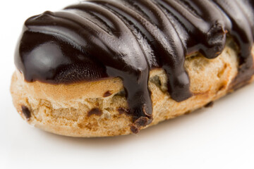 Dessert Bomba de Chocolate. Brazilian traditional éclair on a white background. Close-up macro. Selective focus.