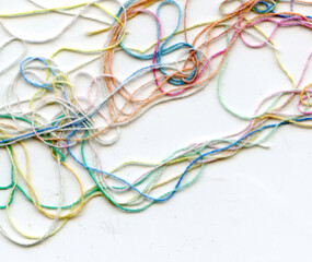 Multicolor tangled color needlecraft silk cord. Abstract color background, in white background