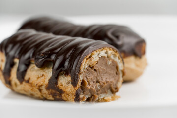 Dessert Bomba de Chocolate. Brazilian traditional éclair on a white background. Close-up macro. Selective focus.