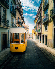 Fototapeta na wymiar The Famous Yellow Tram Going Through The Streets Of Lisbon, Portugal.