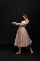 Young girl in white top and peach skirt dancing