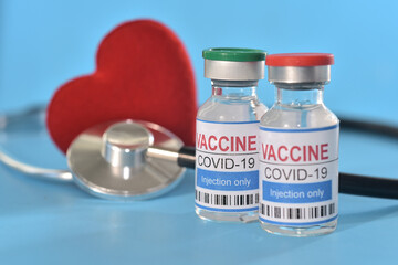 Coronavirus vaccine with the stethoscope and red heart on blue background
