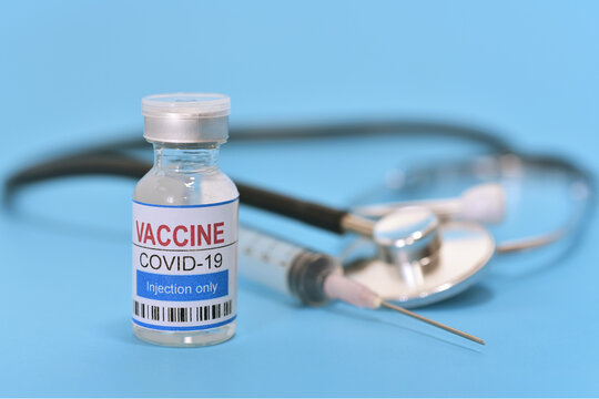 Coronavirus with syringe and stethoscope on blue background