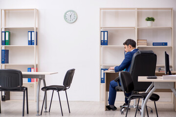 Young male employee and too much work in the office