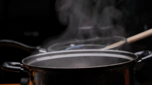Cassava is being boiled in a pot of boiling water to making Thai dessert, Cassava root with coconut milk or Singkong Rebus, traditional Indonesian food.