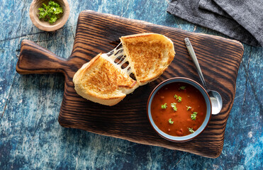 Top down view of a grilled cheese sandwich with tomato soup, ready for eating. - Powered by Adobe