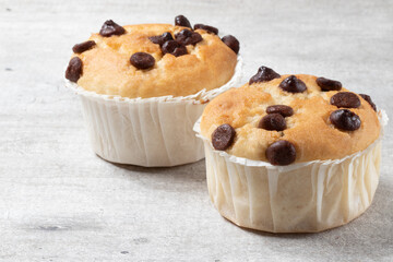 Delicious muffins with drops of chocolate, selective focus.