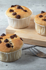 Muffin of chocolate on cutting board, selective focus.