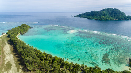 Tropical islands with aquatic marine reefs close to shore.