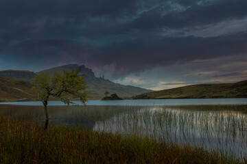 Fototapeta na wymiar Loch Fada with the Old man of storr at sunrise, located on the Isle of Skye, Scotland.
