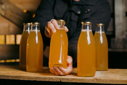 Cider And Apple Juice Bottles Held By The Local Producer