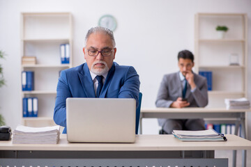 Two male colleagues working in the office
