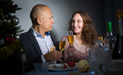 Wife and husband are watching TV on Christmas night. High quality photo