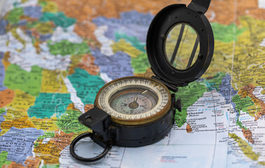 Magnetic compass on world map.Travel, geography, navigation, tourism and exploration concept.