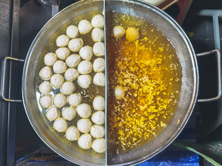The process of making meatballs in a pan of boiling water. Homemade meatballs in a hot frying pan. A simple method of making meatballs, which is the folk wisdom of Thai people. Selective focus.