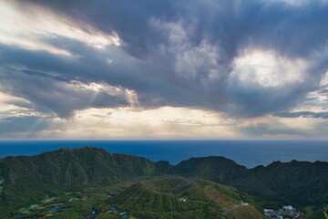Obraz premium The island landscape view of the double caldera with sun lays and clouds in Aogashima, Tokyo