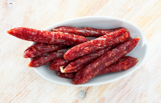 Spicy Spanish Secallona sausages on wooden surface