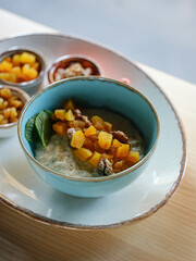 Heathy breakfast with oatmeal and diet fruits, berries and nuts, Home heathy food concept with natural sun light