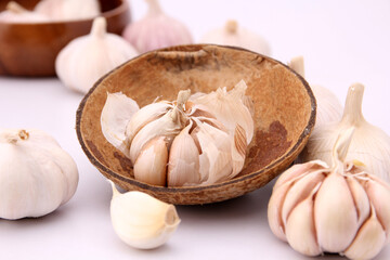 garlic on coconut shell,on white background .