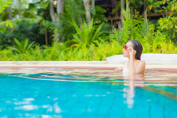 Portrait beautiful young asian woman relax around outdoor swimming pool